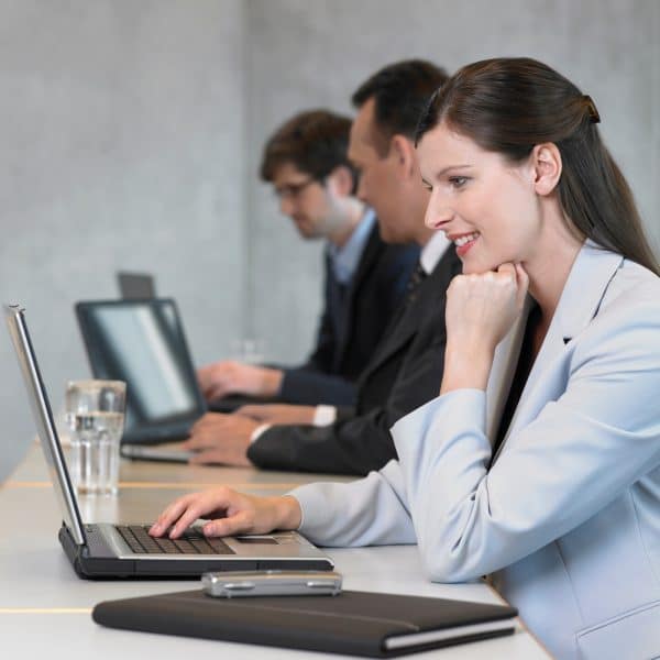 Businesswoman using laptop, smiling