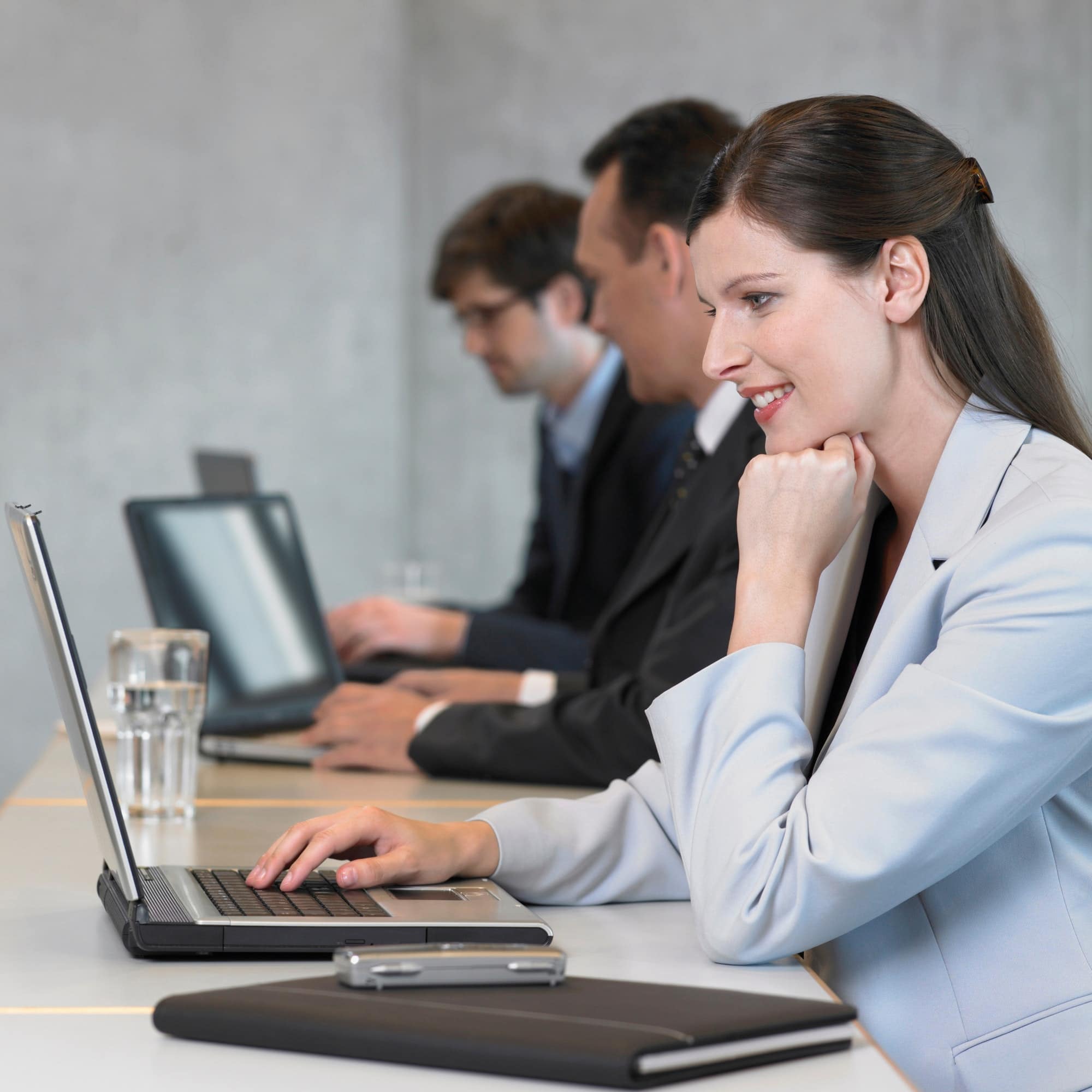 Businesswoman using laptop, smiling